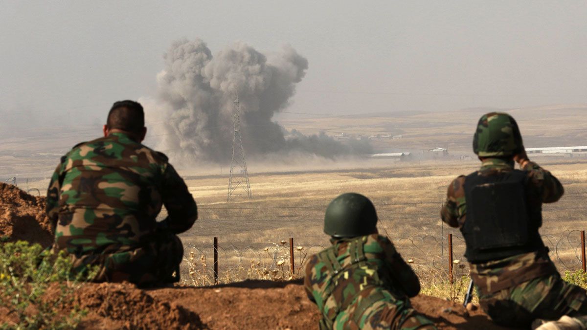 Kurdish Peshmerga fighters hold a position east of the city of Mosul during an operation aimed at retaking areas from IS