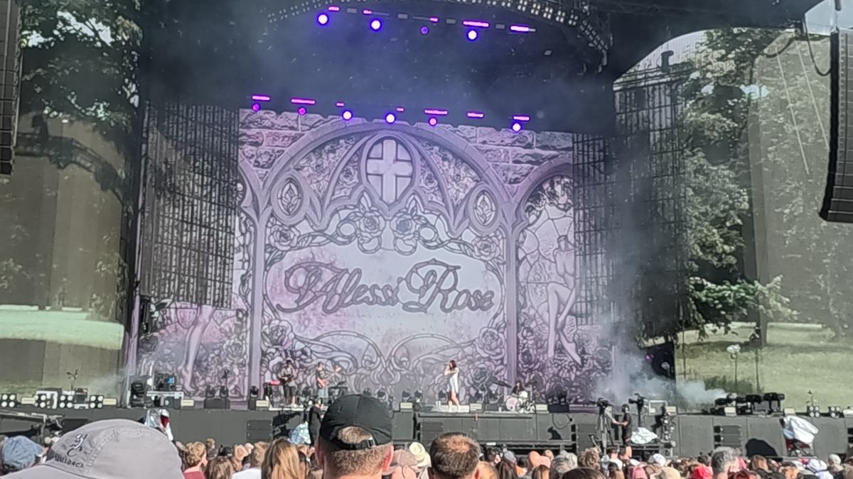 An Alessi rose concert stage with a crowd gathered in front.