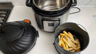 Instant Pot Duo Crisp & Air Fryer next to some fries that were cooked in it