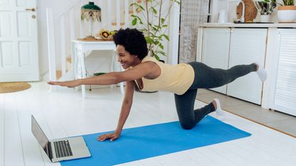 Woman doing Pilates bird dog pose