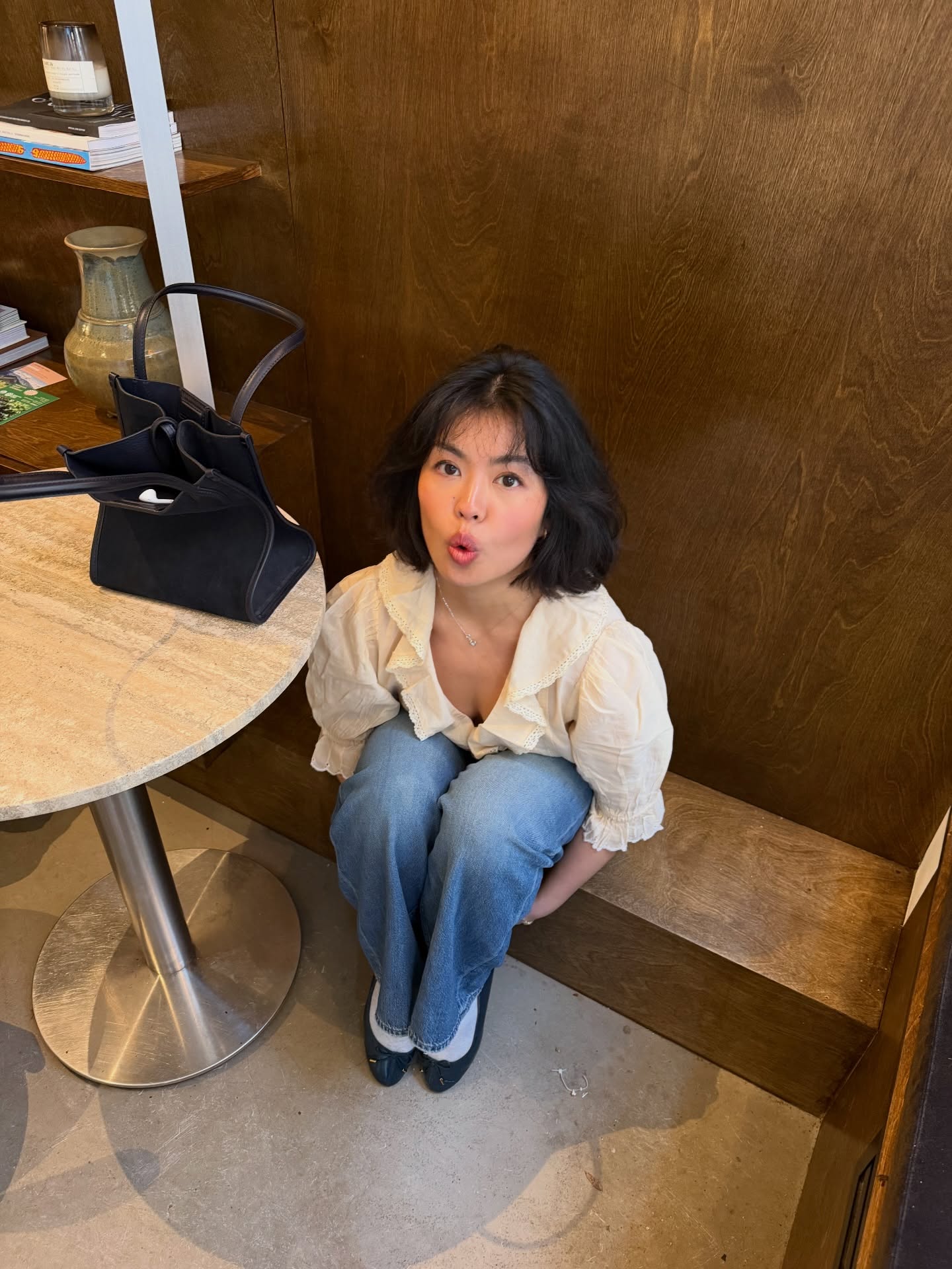 An image of a woman wearing a blouse and jeans summer outfit 2026