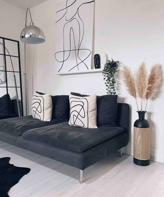 pampas grass in a rattan vase next to a sofa