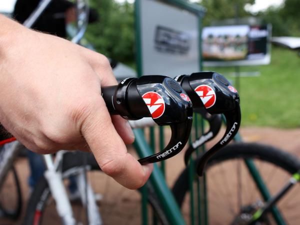 To pull cable - thus shifting to smaller cogs in the back and larger chainrings up front - simply pull the lever as you would if it were a brake. Built-in detents control the indexing.