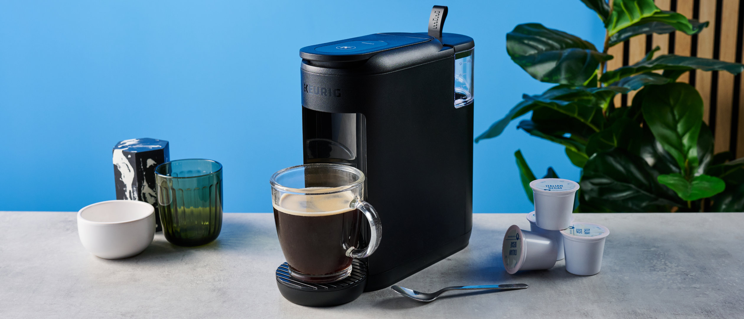 the keurig k-mini mate coffee maker photographed with the blue tom's guide background