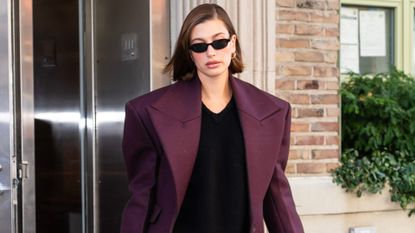 hailey bieber in a leather blazer and mesh flats for work