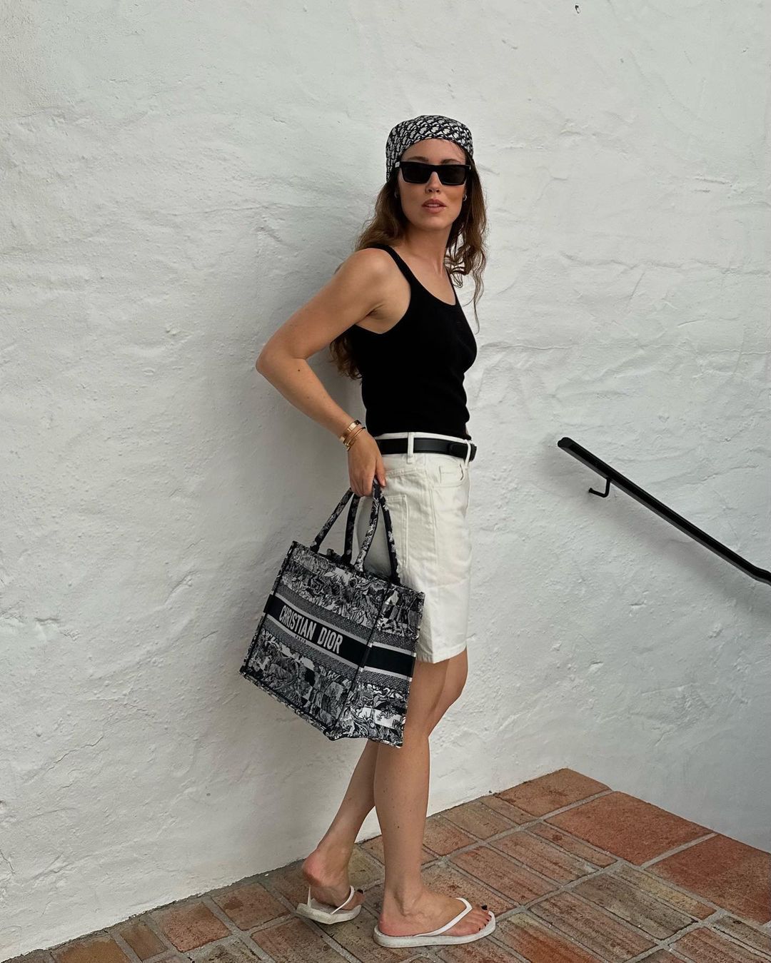 @annabelrosendahl wearing white shorts, a black tank and silk headscarf