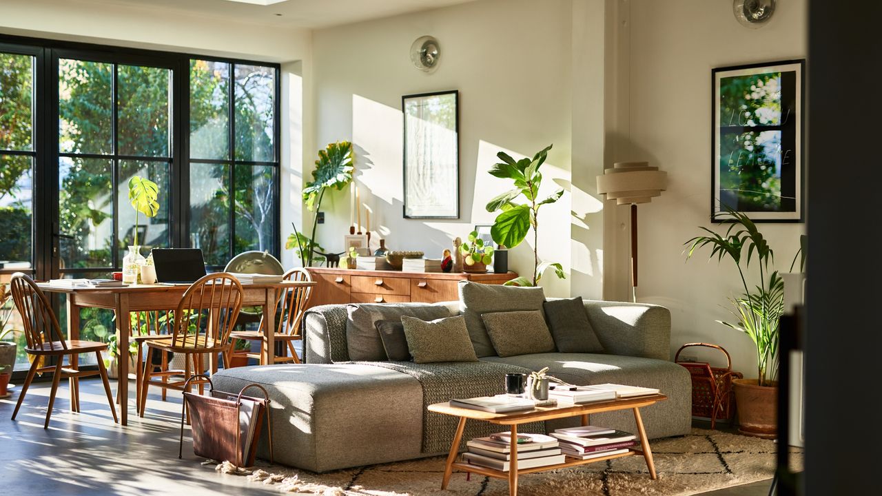 If you&#039;re wondering how to tackle a messy house, this image is one to aspire to. The bright and naturally lit living room has a gray sofa, plenty of storage baskets and clean tables and surfaces