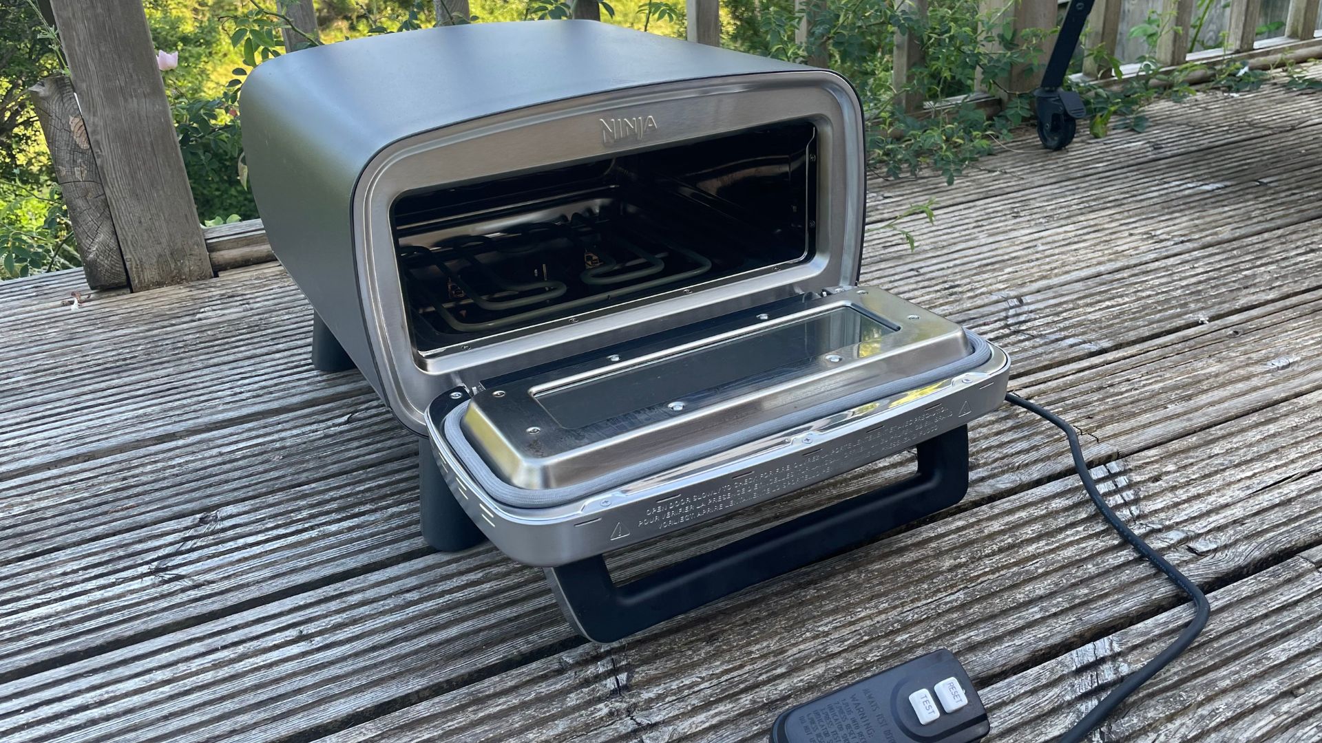 Ninja Artisan Electric Outdoor Pizza Oven and Air Fryer on the deck