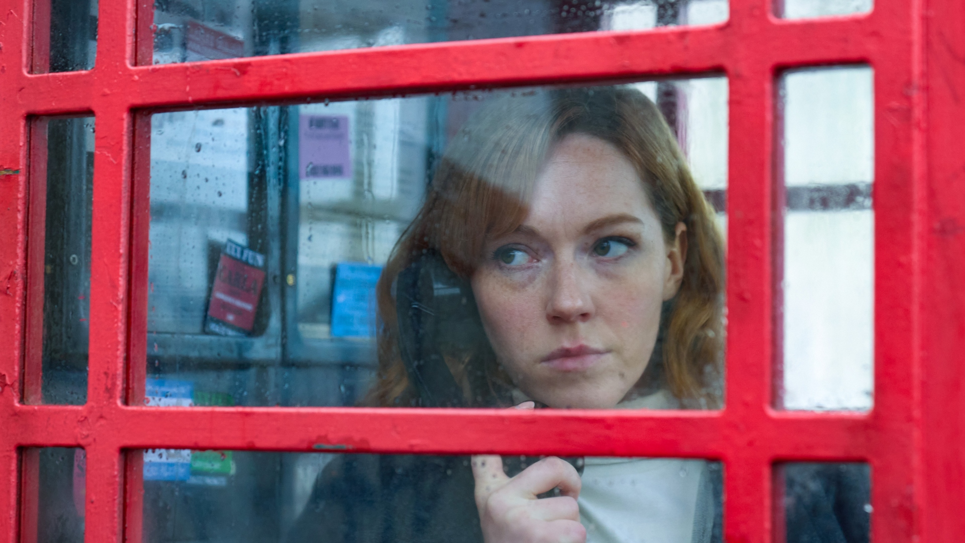 Jennings stands in a phone box in The Gold season 2