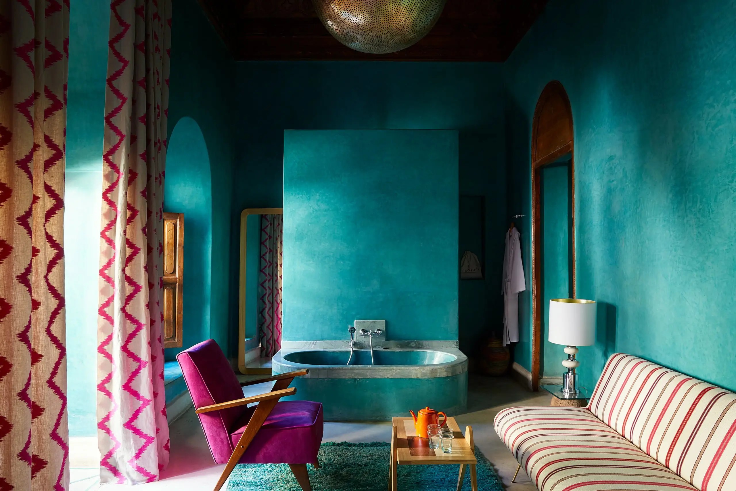 A colorful Moroccan riad has been transformed into a kaleidoscope of patterned textiles, striking artwork, and eye-catching tiles.