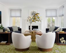 large living room with twin white arm chairs and twin blue sofas