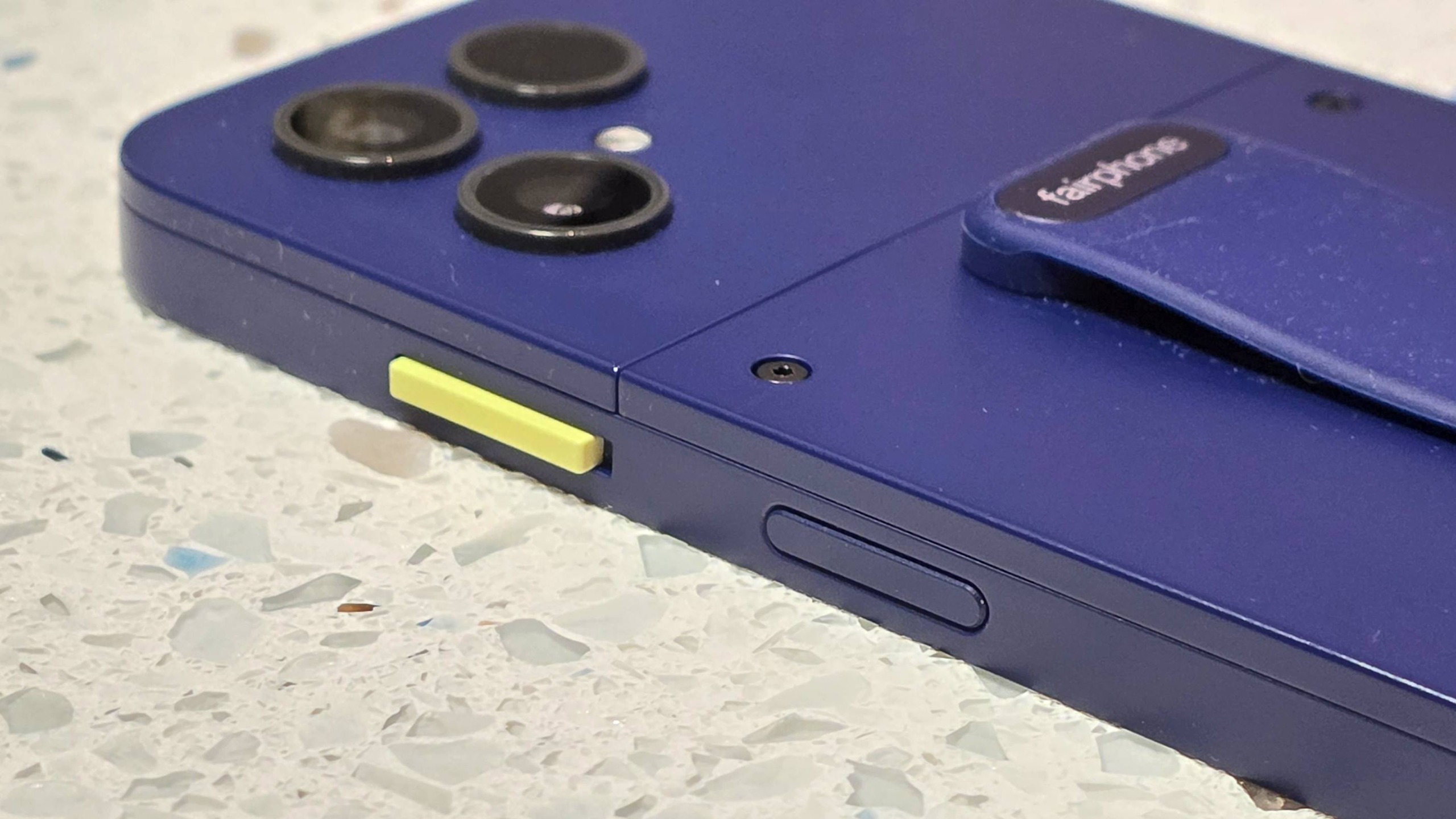 The Fairphone 6 Plus on a table, showing the side switch.