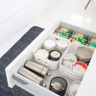 White pull out kitchen drawer with spices