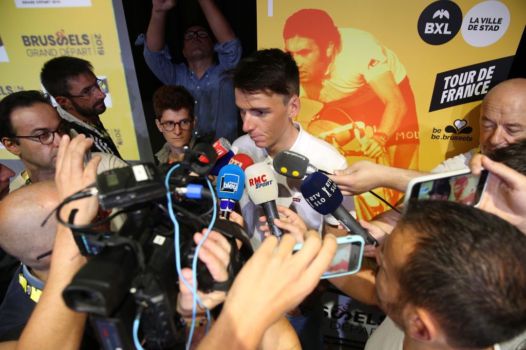 Romain Bardet is swamped by microphones