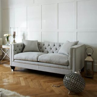white living rom with grey sofa and wooden flooring