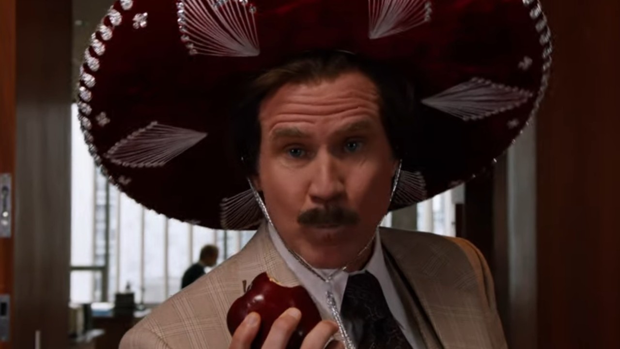 Will Ferrell wearing a sombrero and eating an apple in Anchorman 2: The Legend Continues
