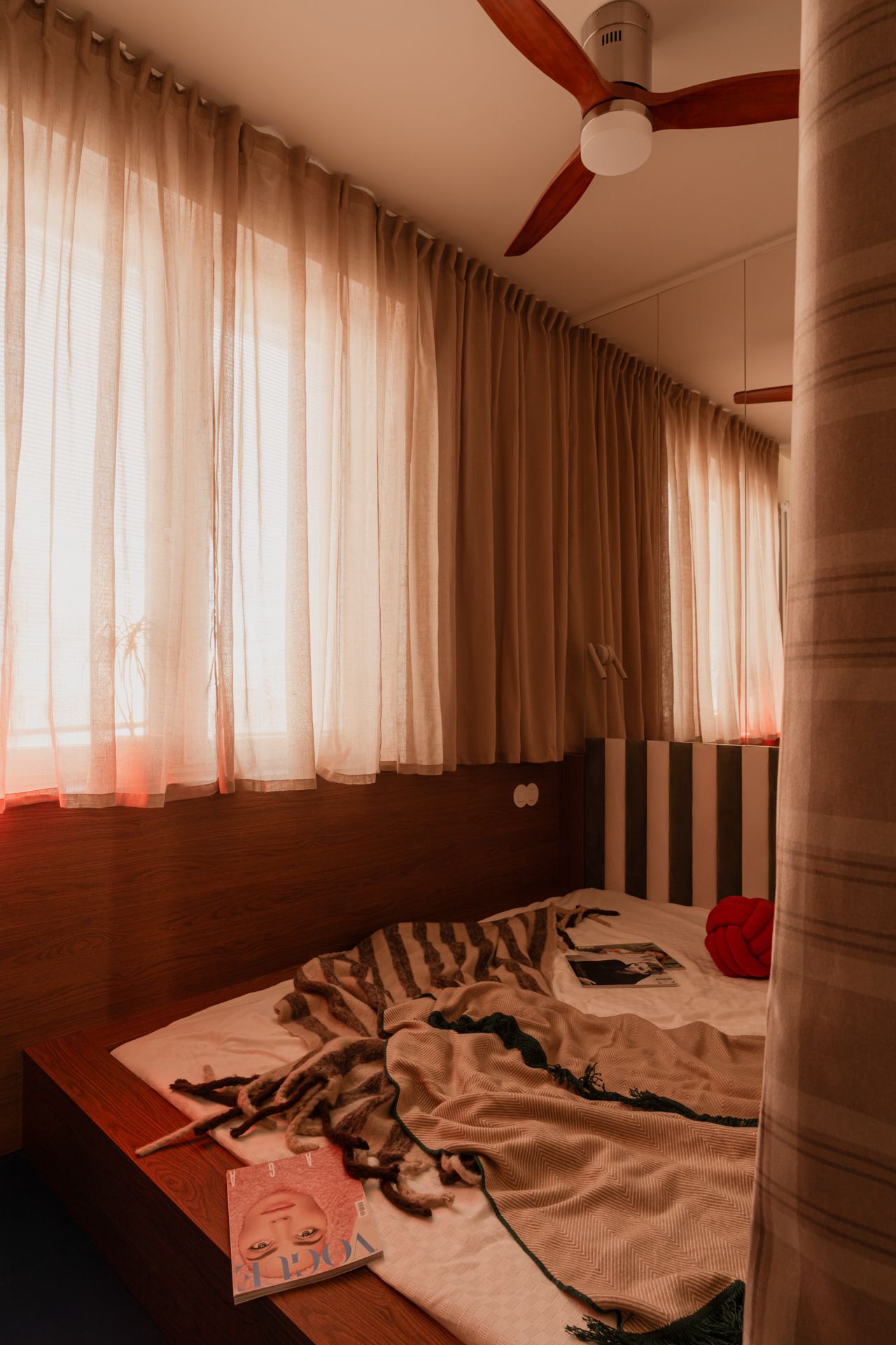 Images of a Warsaw apartment, where curtains help delineate a desk area as well as a sleeping nook.