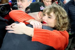 Travis Kelce of the Kansas City Chiefs celebrates with Taylor Swift after a 17-10 victory against the Baltimore Ravens in the AFC Championship Game at M&T Bank Stadium on January 28, 2024 in Baltimore, Maryland.