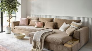 A biscuit coloured sofa in a living room