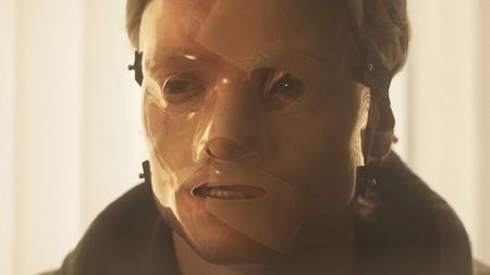 Matt Hagen wearing plastic mask over his face in Clayface