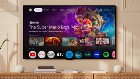 The Google TV Streamer interface with two Google Home Speakers connected on either side 