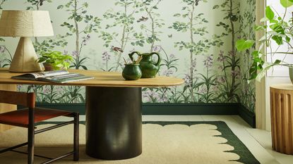 Choosing the best colors to paint a small office might lead you to one like this tranquil green look with natural accents and plant themed wallpaper