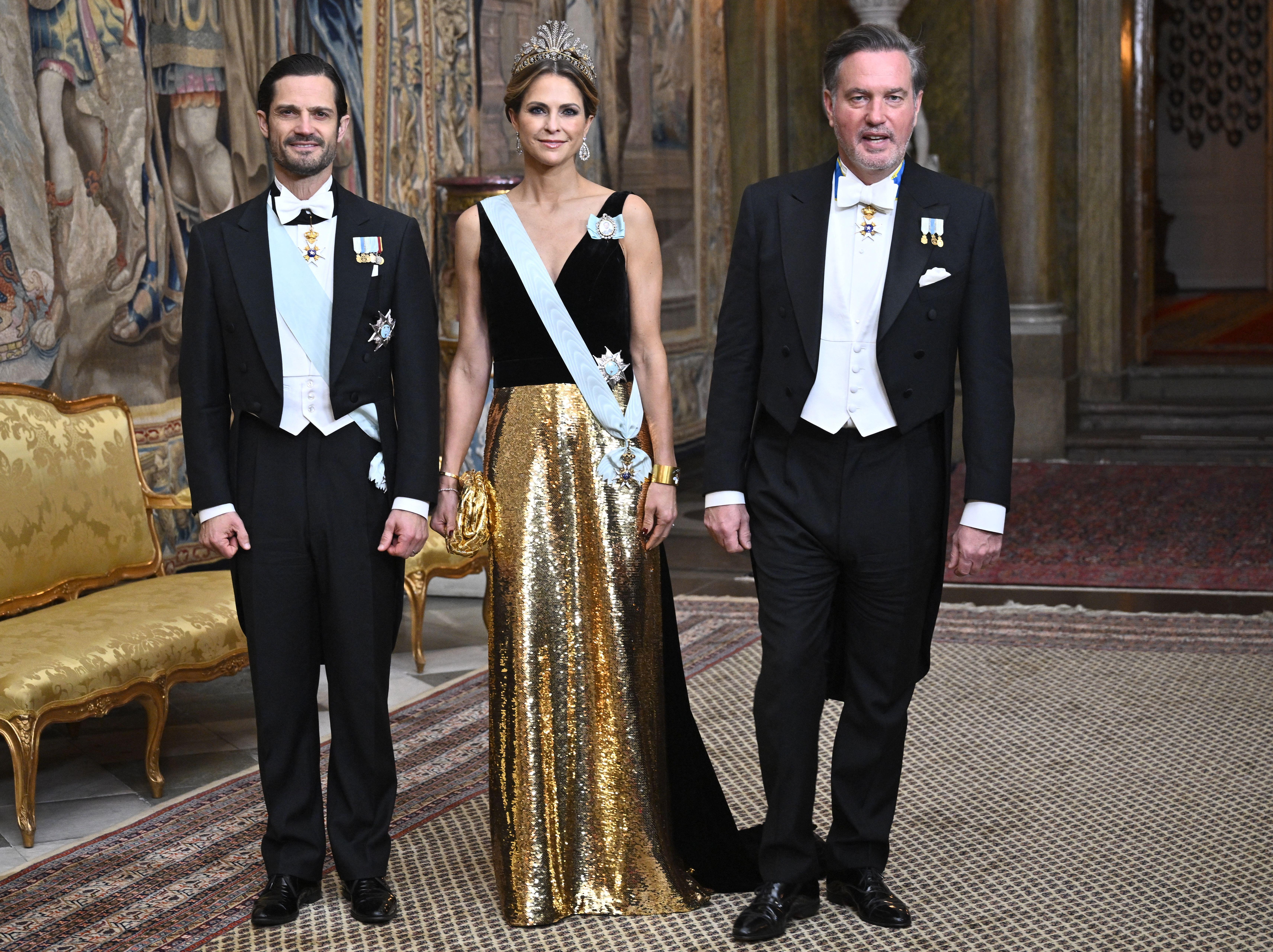 Prince Carl Philip and Princess Madeleine posing with Chris O&#039;Neill at a Nobel dinner