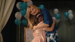 Ellen Pompeo smiles as she hugs Imogen Faith Reid in Good American Family.