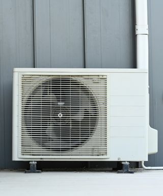Air conditioner (AC) or heating ventilation air conditioning system (HVAC) beside house.