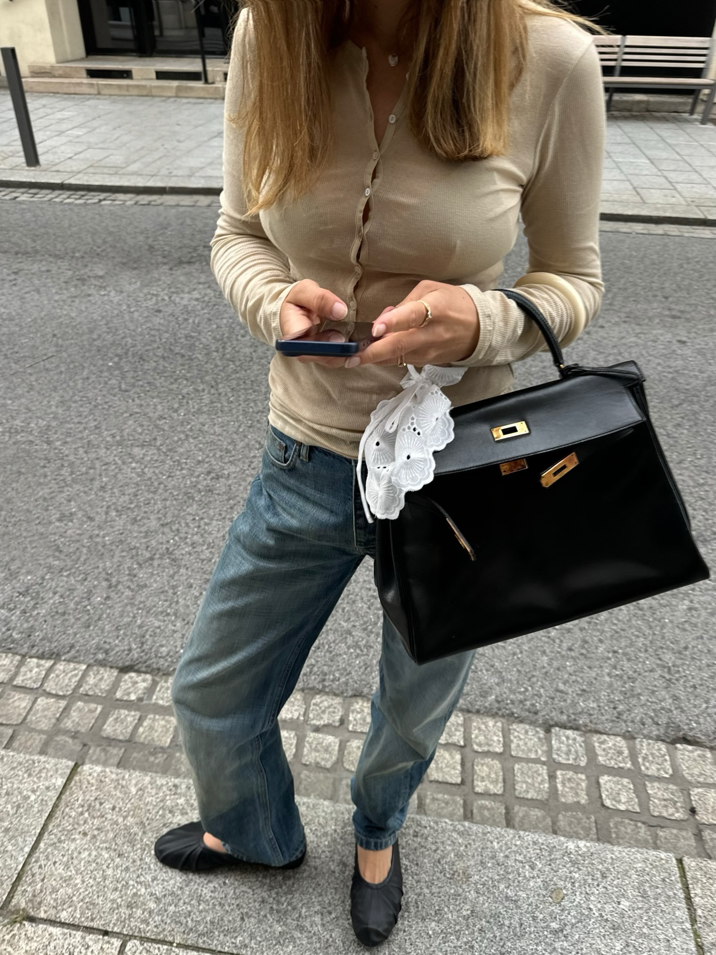 Woman wearing jeans and almond-toe flats.