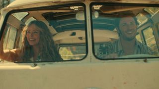 Sarah and Everett smiling through the windscreen of a VW van in Virgin River season 6.