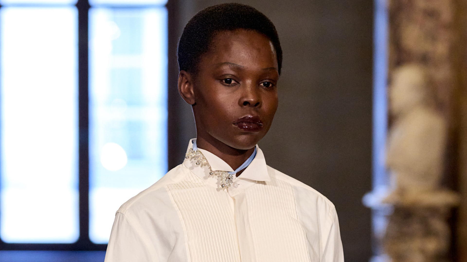 Model wearing a deep purple lip stain.