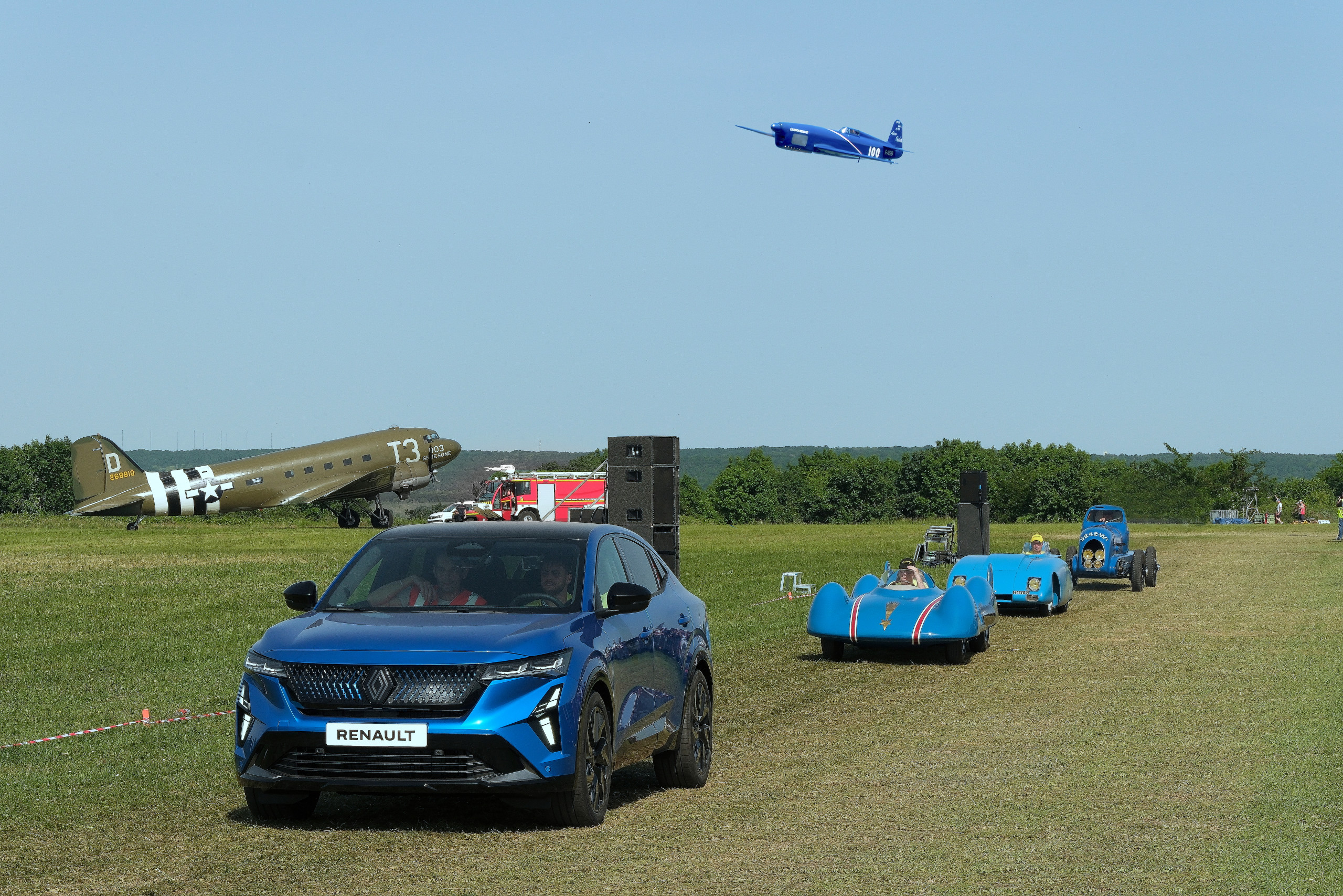 The Renault Caudron Rafale C.460 flies above the Rafale and historic Renault models at Le Temps des Helices air meet in Cerny