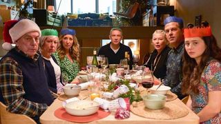 The cast of Breeders season 4 over a Christmas dinner table.