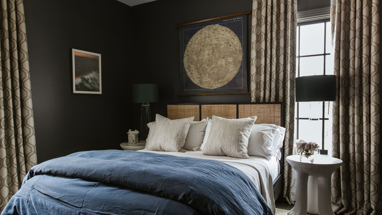 dark grey small bedroom with wicker bed and navy bedding