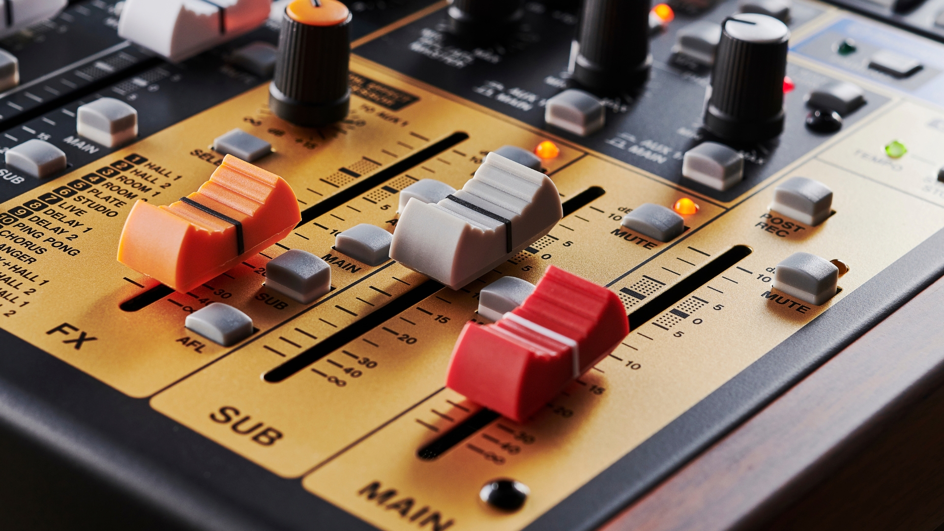 Close up of faders on a home studio mixer