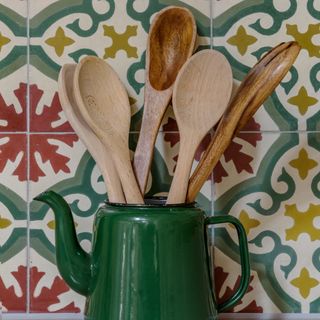 Wooden utensils assortment inside green tea vase
