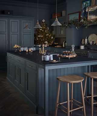 Teal blue kitchen by Kitchen Makers with teal blue walls and brass fittings