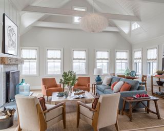 Coastal living room with white walls and orange accents