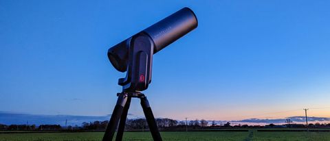 Unistellar eQuinox 2 Telescope in-use against night sky near sunset