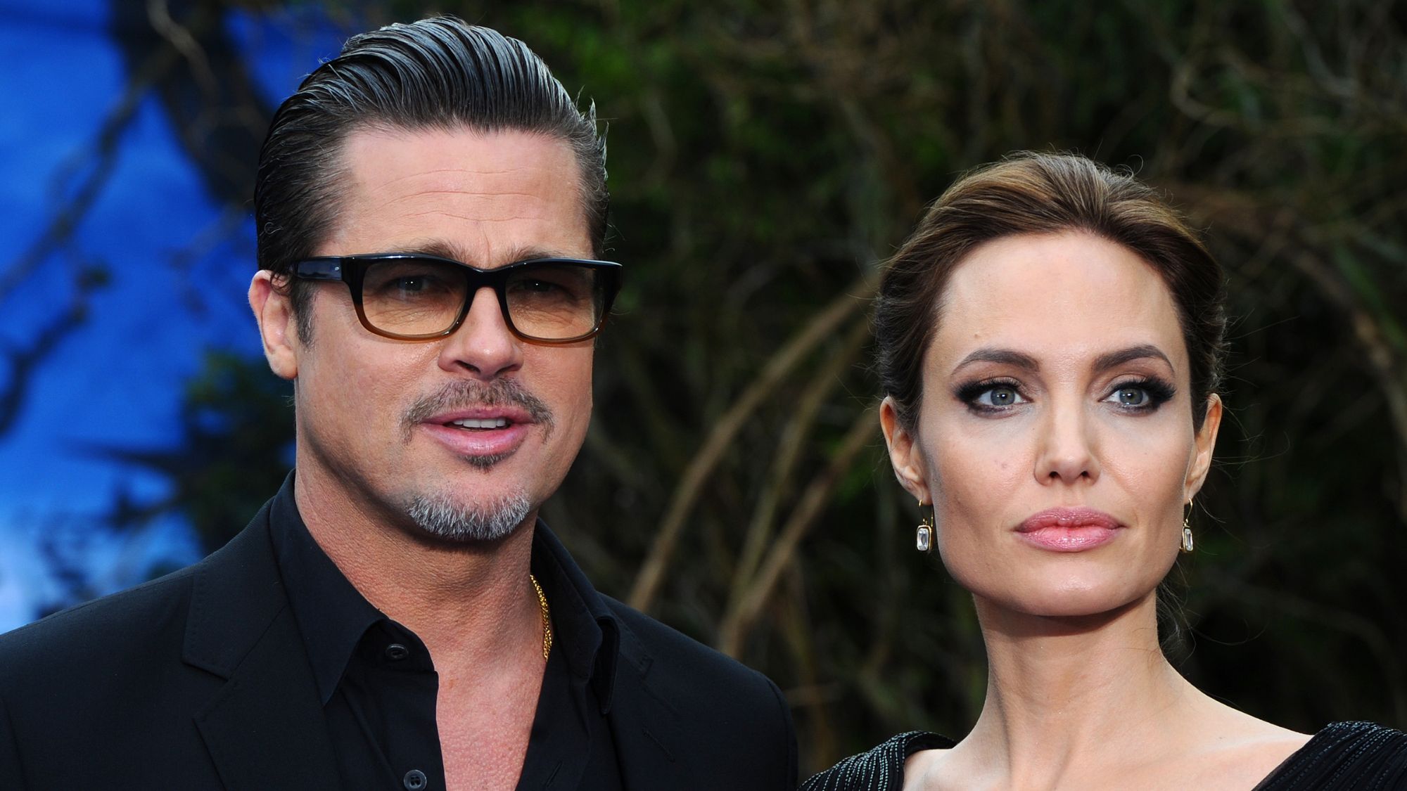 Angelina Jolie and Brad Pitt attend the costume and props private reception for Maleficent