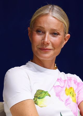 Actress Gwyneth Paltrow looks full of smiles in a bright white t.shirt sporting a pink peony design