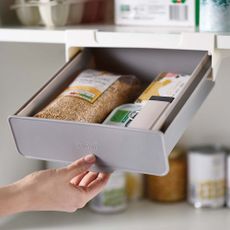 Joseph Joseph Undershelf Drawer in cupboard with hand pulling out and food inside