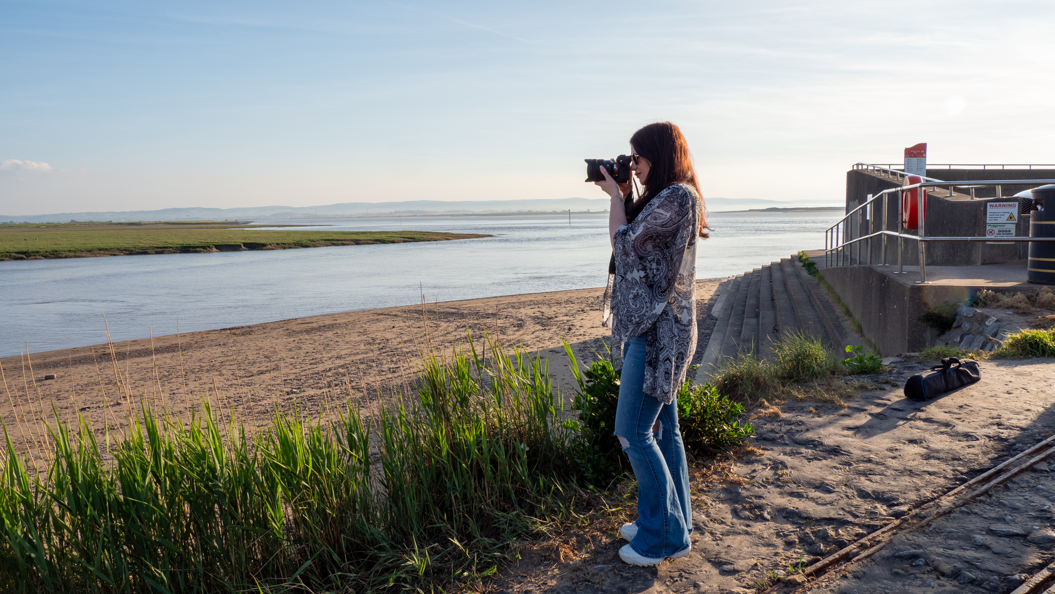 Sony A7 IV being used by a woman by the sea