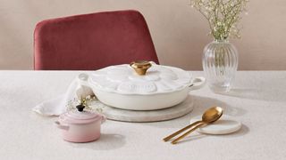 Le Creuset meringue white petal casserole dish on table