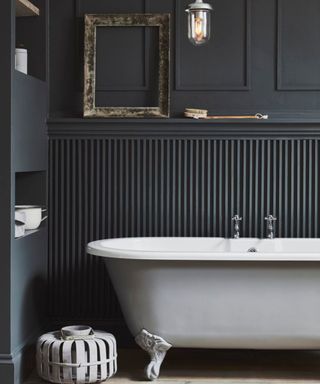 Black small bathroom with white tub