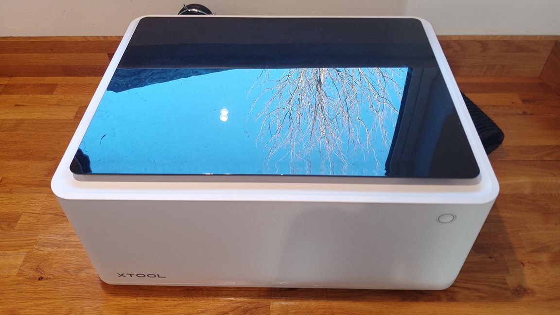 xTool M1 review; a large white box with curved edges and an orange transparent lid, which is closed