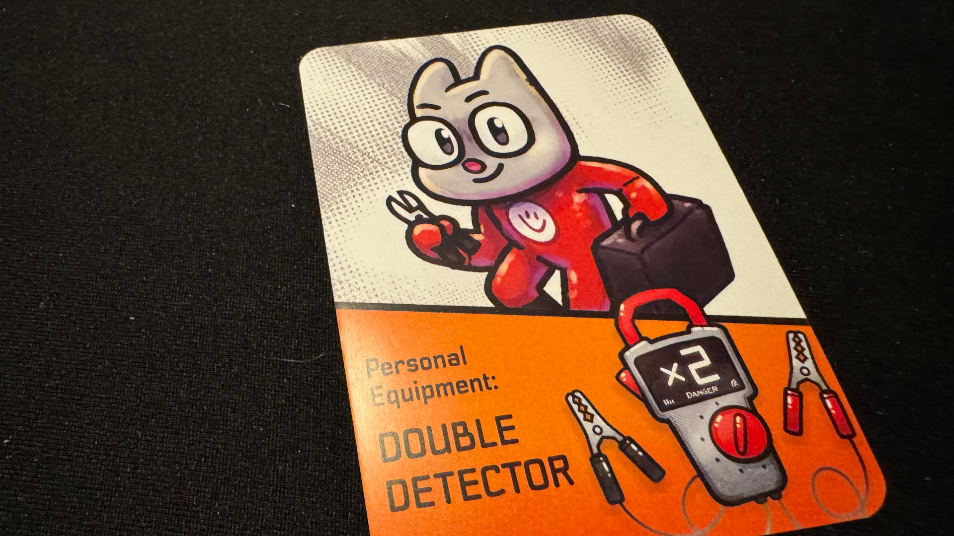 A card showing a cat-like creature in red overalls with plyers, on a black surface