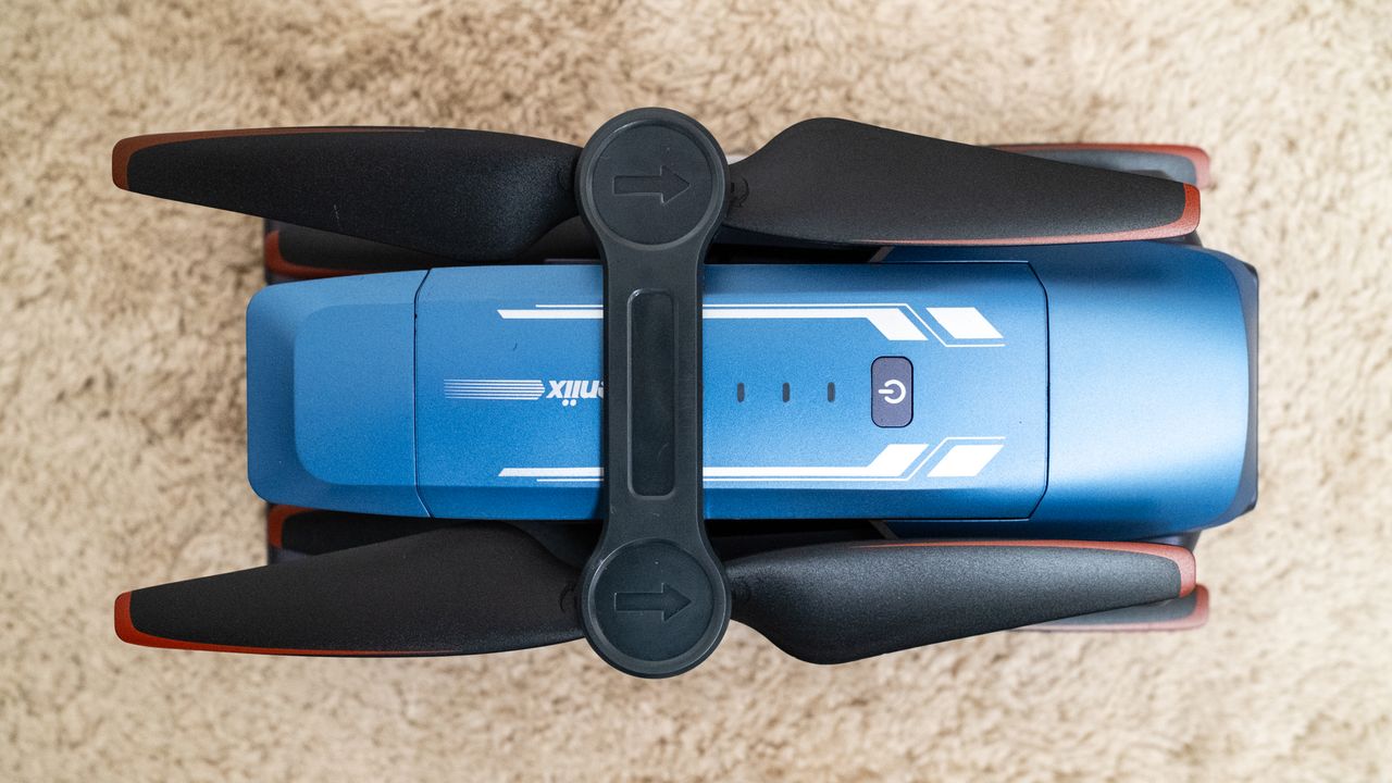 Veeniix V11PRO drone folded on a beige carpet