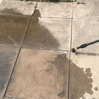 Presusre washer being tested on patio
